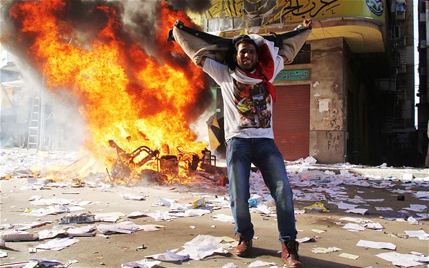 A protestor cheers after a Muslim Brotherhood office was ransacked (Photo: Reuters)