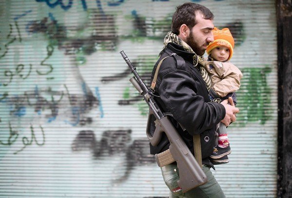 A Syrian opposition fighter and his son in Aleppo (Photo: Odd Andersen / AFP / Getty Images)