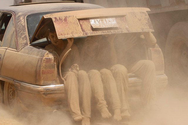 Young men are covered in dust as they flee violence in northern Iraq (Photo: Rodi Said / Reuters) 