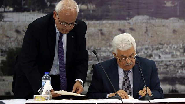 Palestinian Authority President Mahmoud Abbas recently signing a number of international treaties, including the Rome Statute (Photo: EPA)