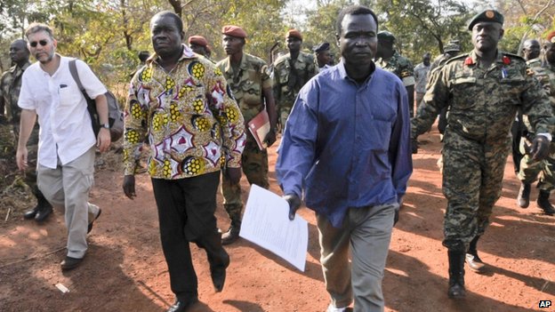 Dominic Ongwen walks with members of an African Union Regional Task Force prior to his surrender to the ICC (Photo: AP)