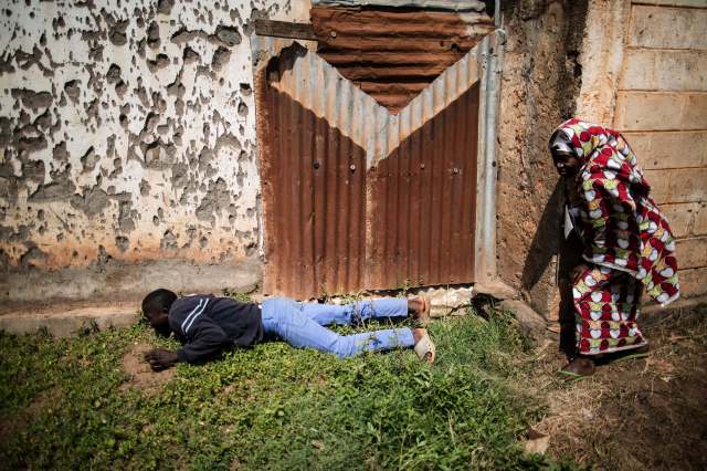 Muslim civilians in Bangui take cover to avoid heavy gunfire directed towards the Baya Dombia school where voters were gathering for the Constitutional Referendum on December 13, 2015. (Photo: Marco Longari / AFP)