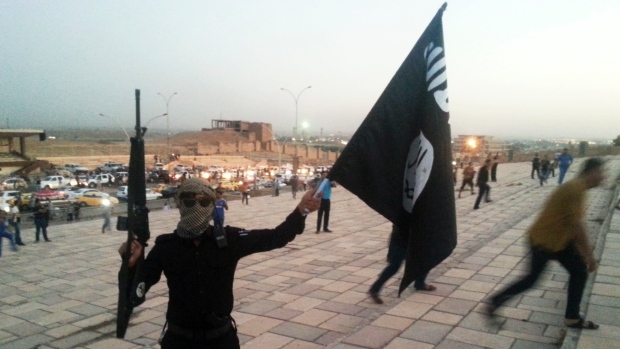 An ISIS fighters waves a flag in Iraq (Photo: Reuters)
