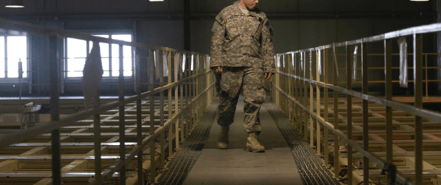 An American military guard looks over detainee cells at a detention facility near Bagram Air Field.(Photo: Dar Yasin / AP) 